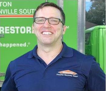 Bryce Clark Owner SERVPRO Jacksonville South, male with blue shirt and glasses