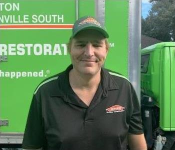 Kyle posing in front of SERVPRO truck