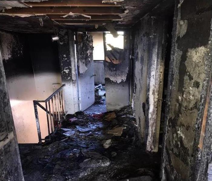 A room covered in soot and smoke damage after a fire