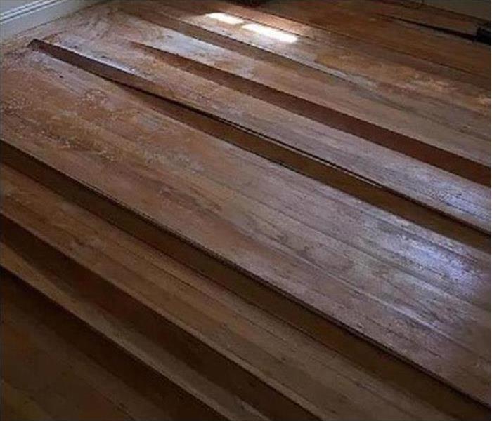 warping hardwood floor due to water damage