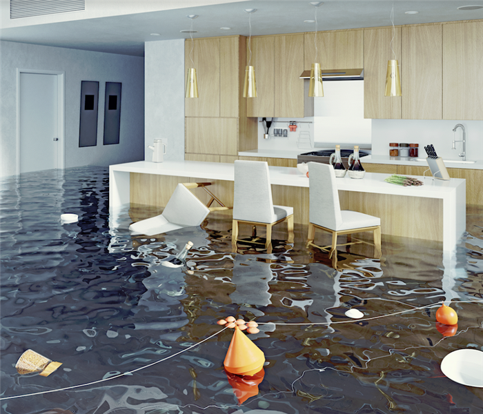 a flooded kitchen with chairs and items floating everywhere